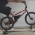 Thumbnail for Photo of someone using a bmx to practice manuals on a wooden frame for support