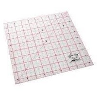 A large, transparent quilting ruler with grid lines.