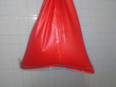 A piece of seam-taped 70D ripstop nylon fabric being tested for waterproofness.