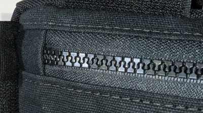 Zipper being sewn to a panel piece.